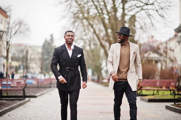 Premium Photo | Two fashion black men walking on street. fashionable ...
