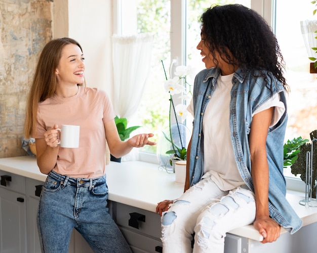 Free Photo Two Female Friends Having A Conversation At Home Over Coffee