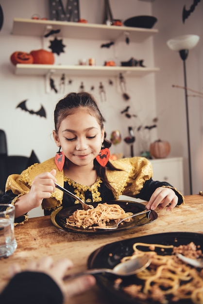 Two girl in costume having lunch Premium Photo