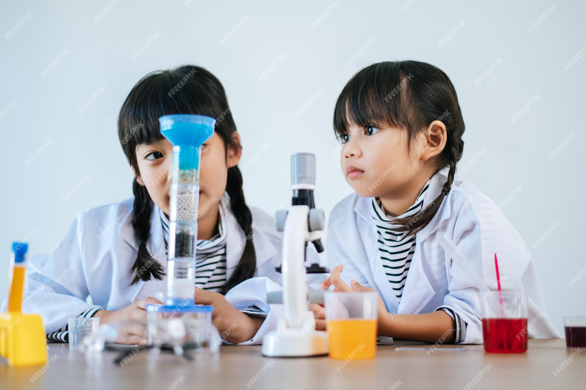 Premium Photo | Two girls doing science experiments in a lab. selective ...