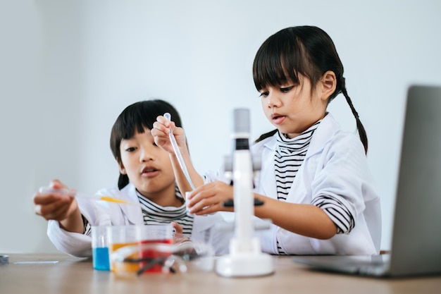 Premium Photo | Two girls doing science experiments in a lab. selective ...