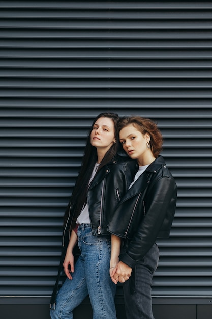 Premium Photo Two Girls In Leather Jackets Posing