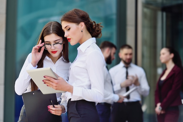 Premium Photo | Two girls in office style clothes on building background