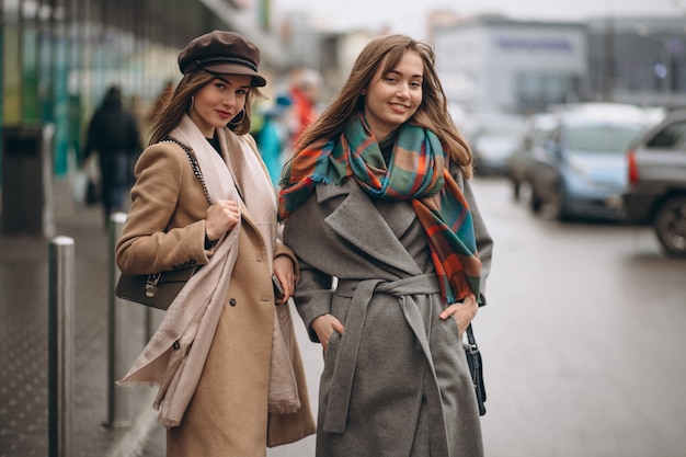 Premium Photo | Two girls outside shopping mall in an autumn day