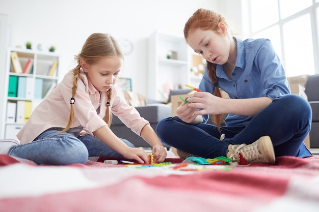 Premium Photo Two Girls Playing With Toys At Home