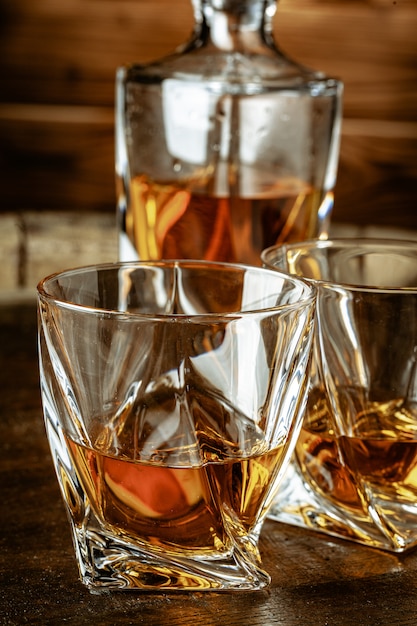 Premium Photo | Two glasses of brandy or cognac and bottle on the ...