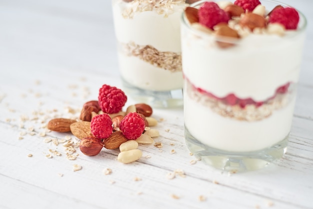 Premium Photo | Two glasses of greek yogurt granola with raspberries ...