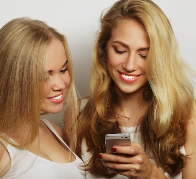 Premium Photo Two Happy Women Friends Sharing Social Media In A Smart