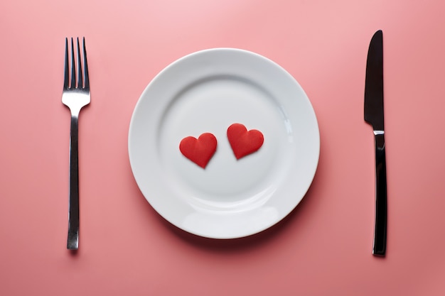 Two Hearts In Plate With Cutlery Romantic Dinner In Restaurant