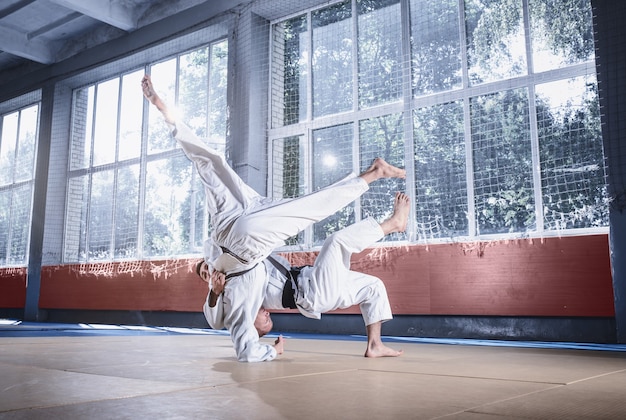 Premium Photo | Two judo fighters showing technical skill while ...