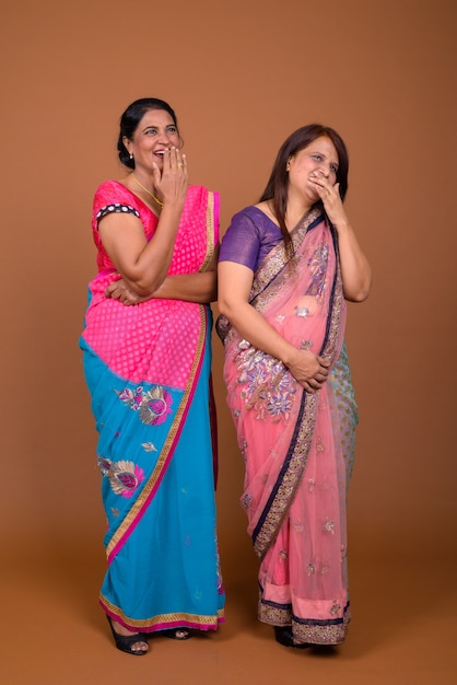 Premium Photo Two Mature Indian Women Wearing Sari Indian Traditional Clothes Together 