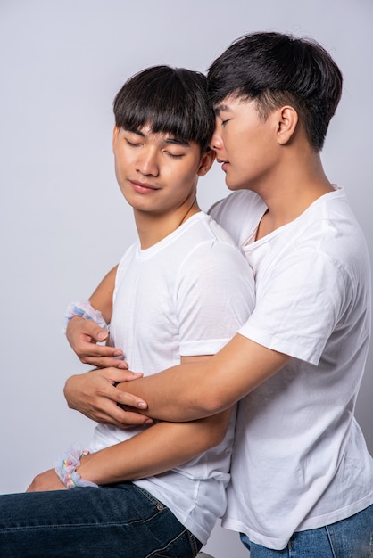 Free Photo Two Men Who Love Each Other Hug From Behind Another