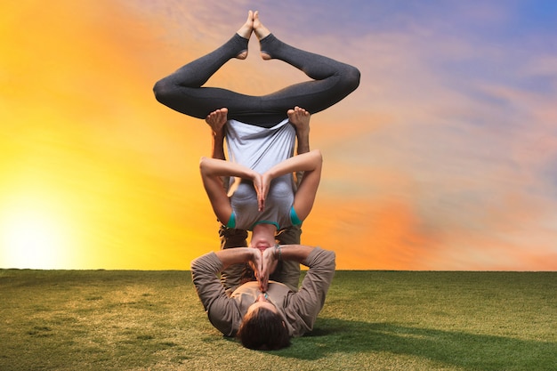 Two people doing yoga exercises | Free Photo