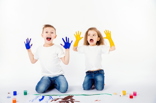 Premium Photo Two Pretty Child Friends Boy And Girl Are Drawing Pictures By Paints