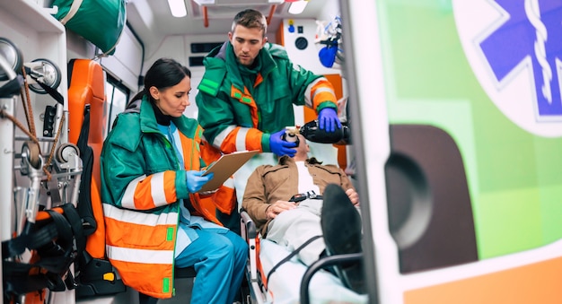 Premium Photo | Two professional paramedics in an ambulance car with a ...