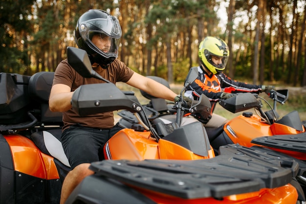 Premium Photo Two Quad Bike Riders In Helmets And Equipment Side View Closeup Summer Forest On Background Male Quadbike Drivers Atv Riding Extreme Sport