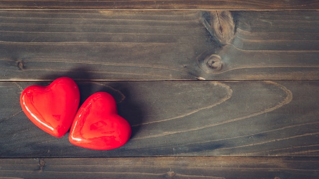 Premium Photo | Two red heart on wood table background with copy space