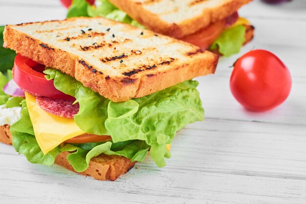 Premium Photo | Two sandwiches with ham, lettuce and fresh vegetables ...