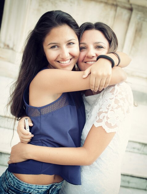 Premium Photo Two Sisters Embracing