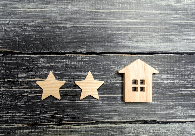 Two stars and a house. concept of the rating of a hotel or restaurant. Premium Photo