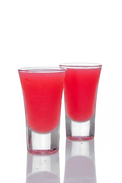 Premium Photo | Two strawberry cocktails in shot glass with reflection ...