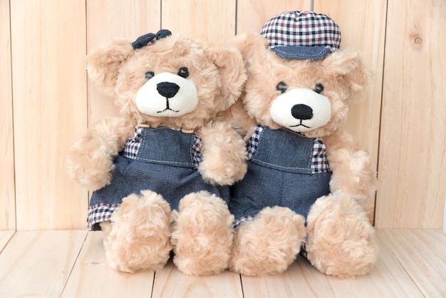 two teddy bears on wood background Free Photo