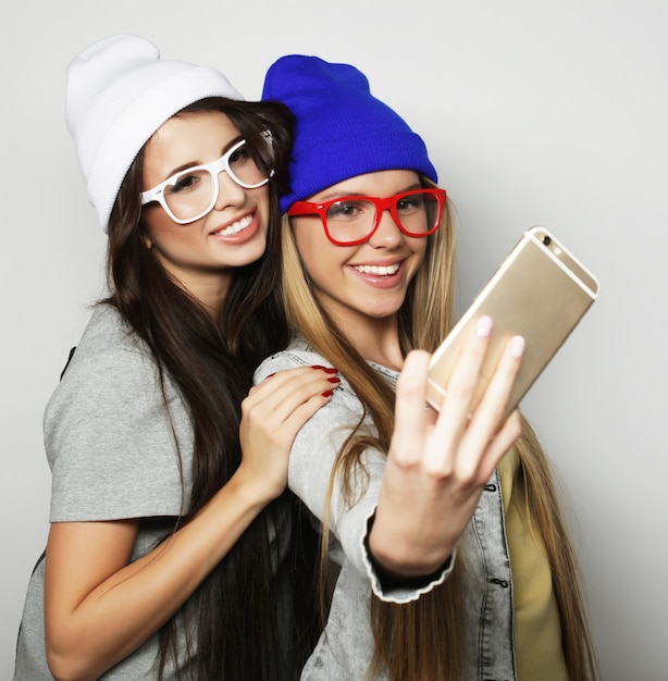 Premium Photo Two Teenage Girls Friends In Hipster Outfit Make Selfie Over White Background 4885