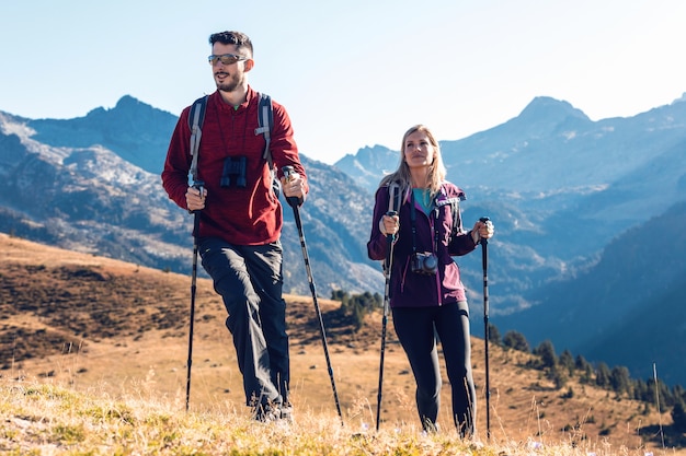 Premium Photo | Two Travel Hikers With Backpack Walking While Looking ...