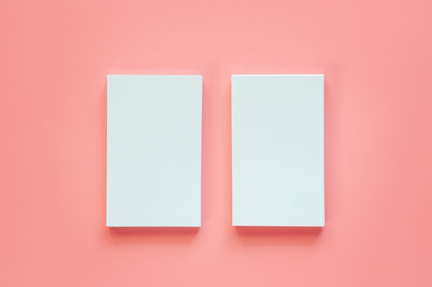 two vertical of blank business cards on pink background