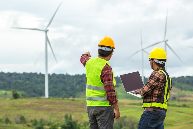 Premium Photo | Two windmill engineer inspection and progress check ...