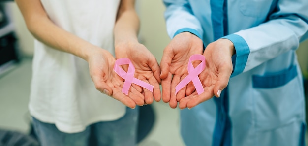 Premium Photo | Two women showing cancer awareness medical stick ribbon ...