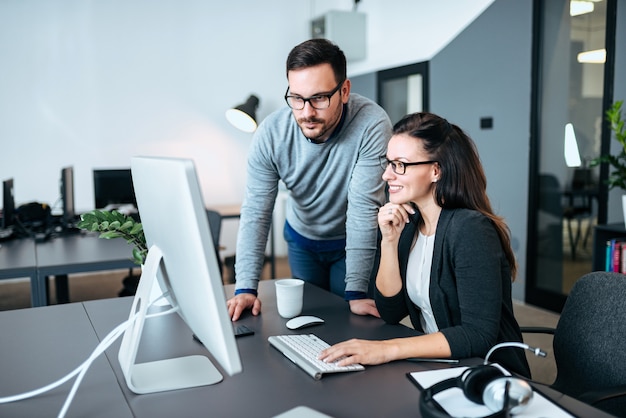 Premium Photo | Two young business people looking at ...