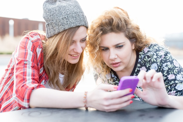 Premium Photo | Two young curly and straight blonde hair woman