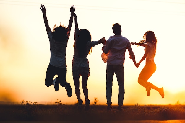 Premium Photo | Two young guys and two girls are holding their hand and ...