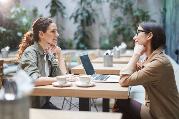 Premium Photo | Two young women in cafe