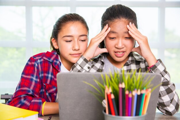 Two youngster looking computer screen and surprised frustrated or disappointed of trouble Premium Photo