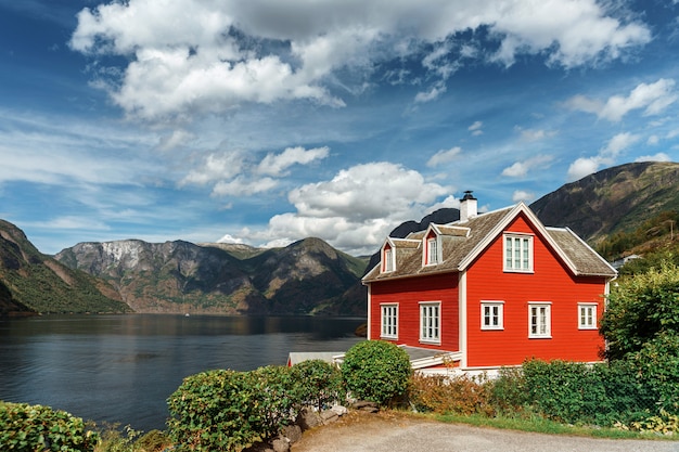 Premium Photo | Typical norwegian red house in the background of a ...