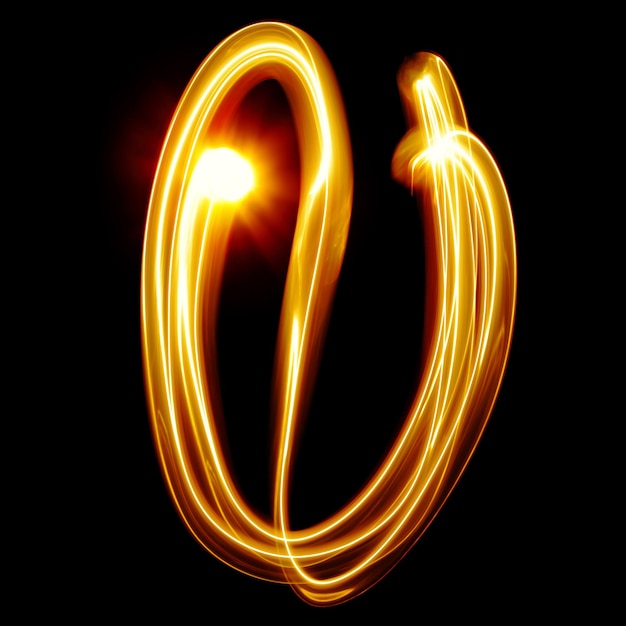 Premium Photo | U - created by light alphabet over black background