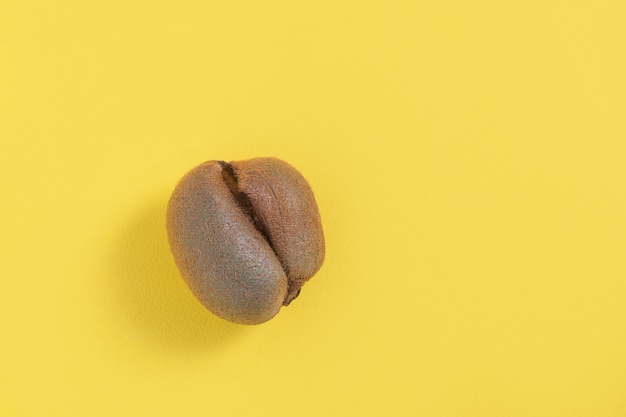 Premium Photo | Ugly misshapen fruit kiwi on yellow background