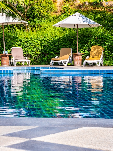 Umbrella And Chair Around Luxury Outdoor Swimming Pool Photo