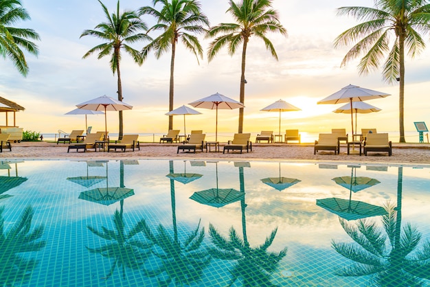 Premium Photo | Umbrella and chair around swimming pool in hotel resort ...