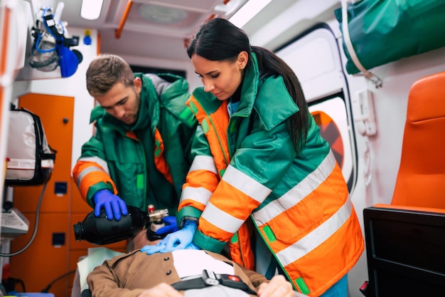 Premium Photo | Unconscious Senior Man And Working Paramedics In The ...