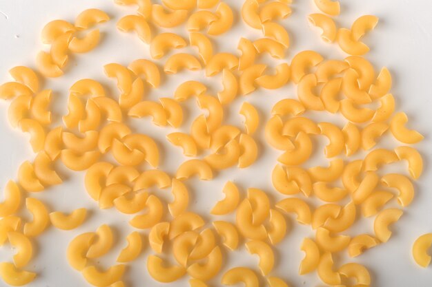 premium-photo-uncooked-elbow-macaroni-on-a-white-background