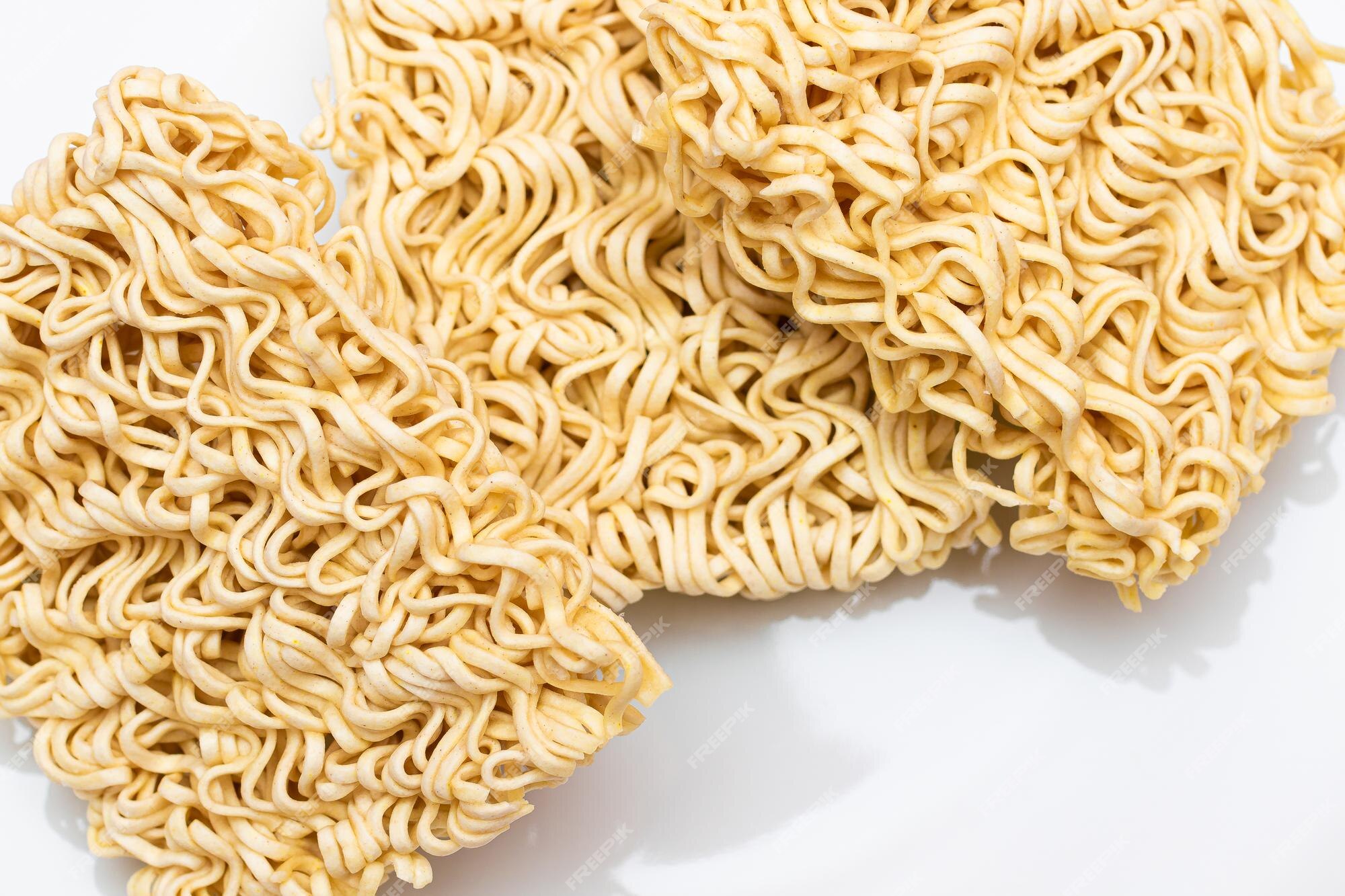 Premium Photo | Uncooked instant noodles on white plate