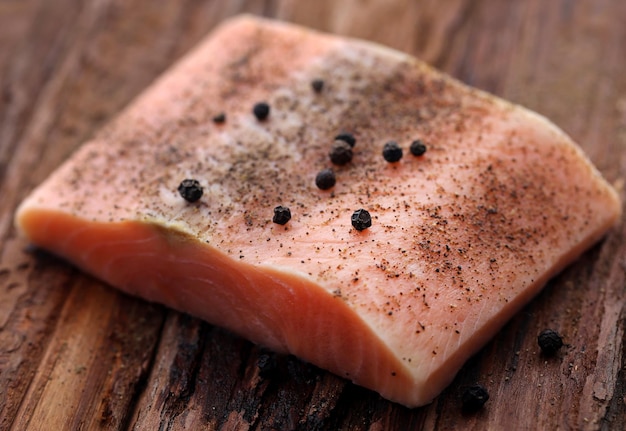 Premium Photo | Uncooked salmon fish on wooden surface