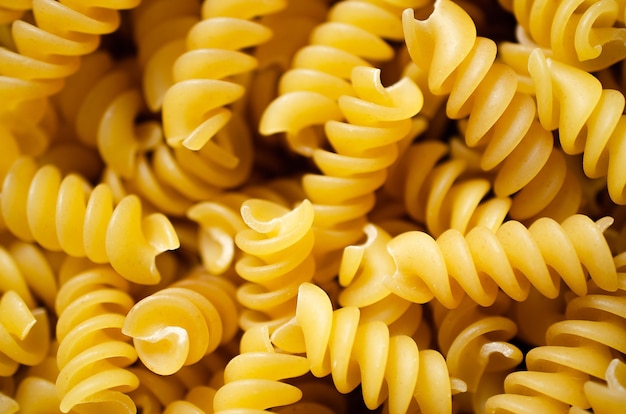 Premium Photo | Uncooked spiral pasta