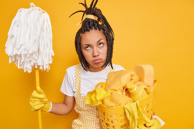 Premium Photo Unhappy Housewife Feels Tired Holds Mop Laundry Basket