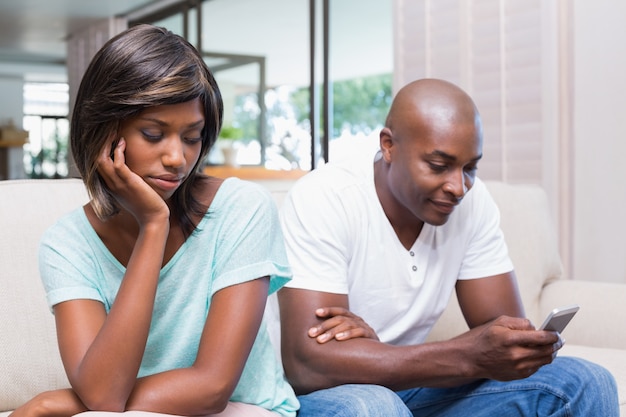 Premium Photo | Unhappy woman watching her boyfriend texting