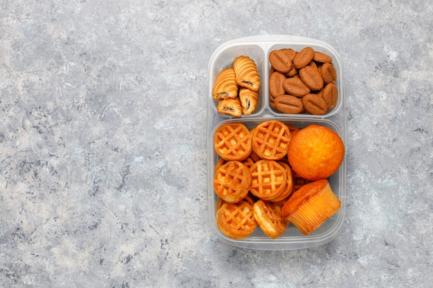 Free Photo Unhealthy Lunch Box With Cookieswafflesmuffins On