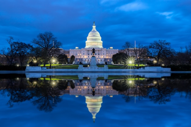 Premium Photo | The united states capitol with reflection at night ...